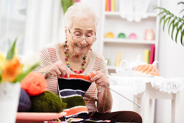 Smiling grandmother knitting